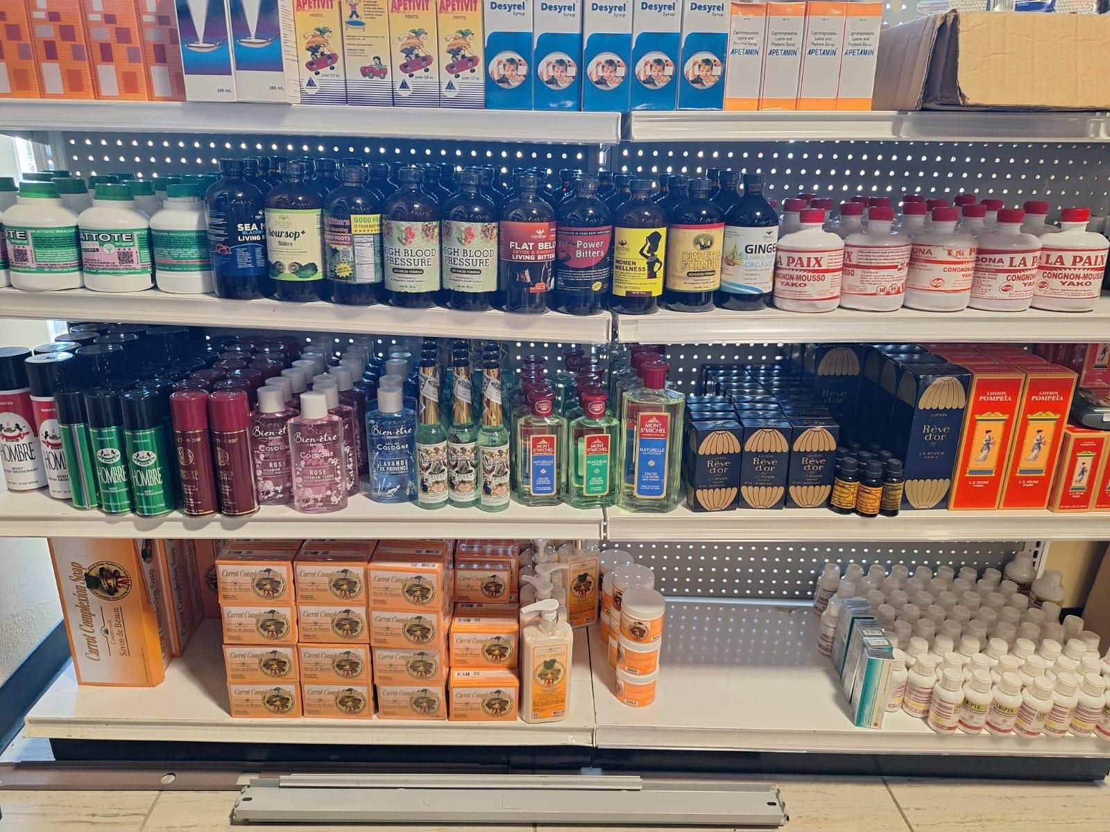 Health and beauty shelves at JNS Food Market — Haitian bitters and tonics, colognes, carrot complexion soap, lotions, and vitamins.